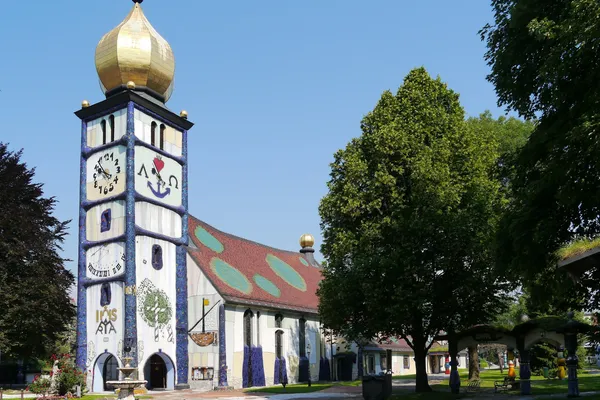 Hundertwasserkirche St. Barbara in Bärnbach mit goldener Zwiebelkuppel und bunter Fassade